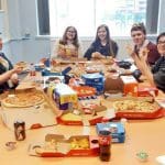 Senedd members eating pizza