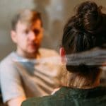 Time to talk - image shows a man and woman sitting down at a table having a conversation.